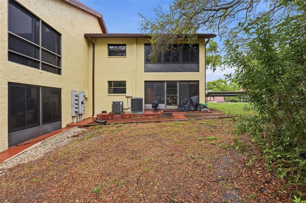 7650 Forest Trail, Unit 6 Port Richey, FL 34668 - Photo 31 of 37 a view of a house with backyard porch and furniture