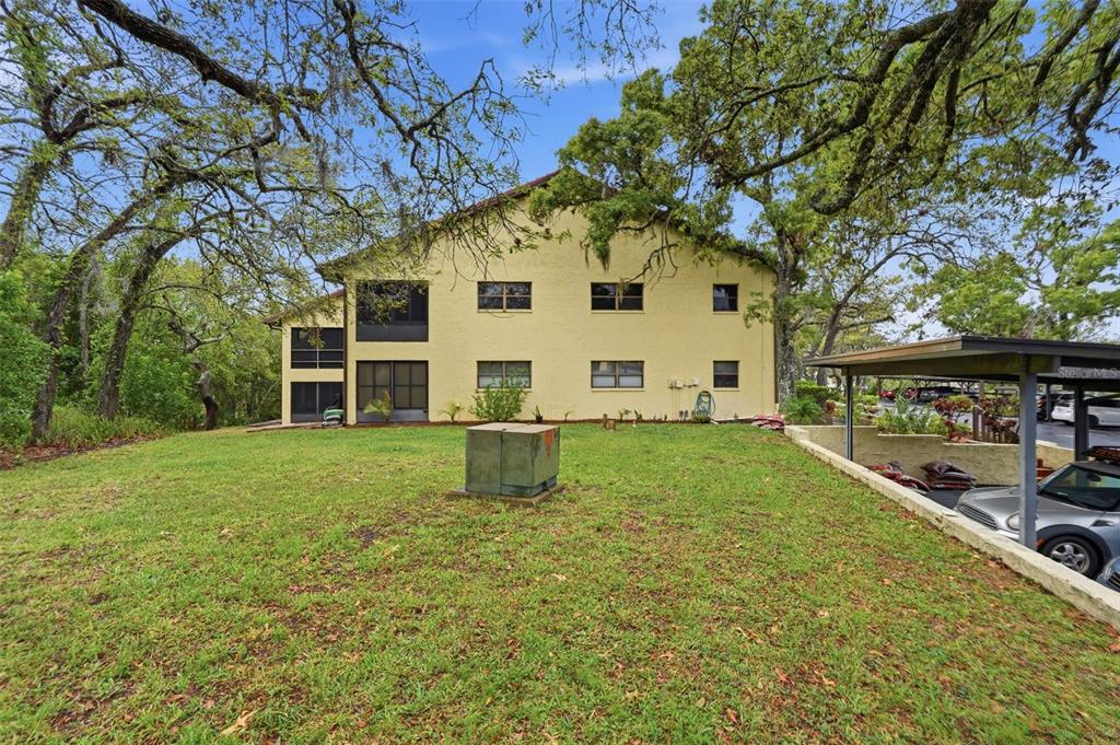 7650 Forest Trail, Unit 6 Port Richey, FL 34668 - Photo 32 of 37 a view of a house with a yard