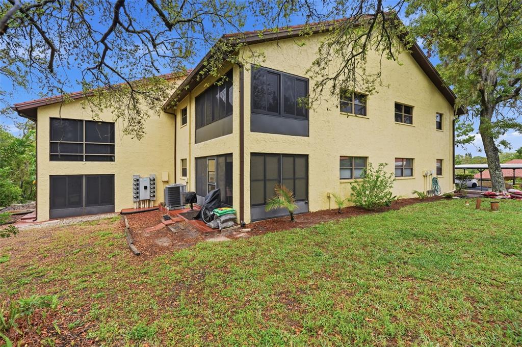 7650 Forest Trail, Unit 6 Port Richey, FL 34668 - Photo 33 of 37 a view of a house with backyard
