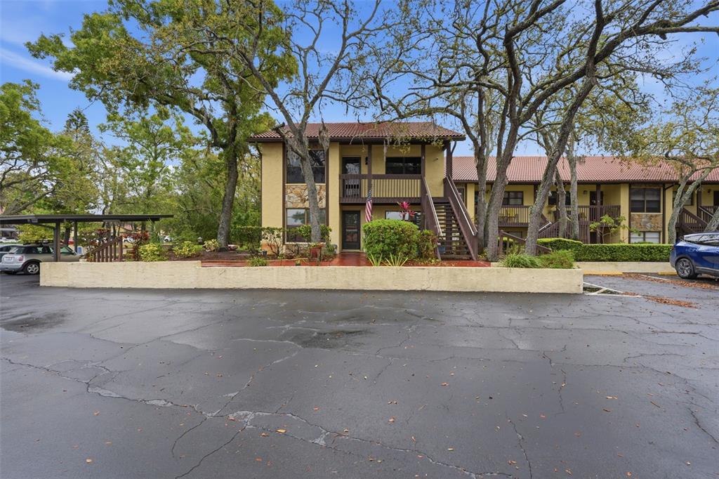 7650 Forest Trail, Unit 6 Port Richey, FL 34668 - Photo 34 of 37 front view of a house with a yard