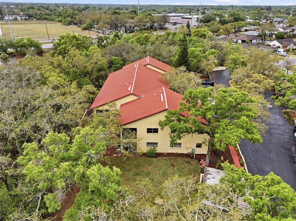 7650 Forest Trail, Unit 6 Port Richey, FL 34668 - Photo 36 of 37 an aerial view of a house with a yard and lake view
