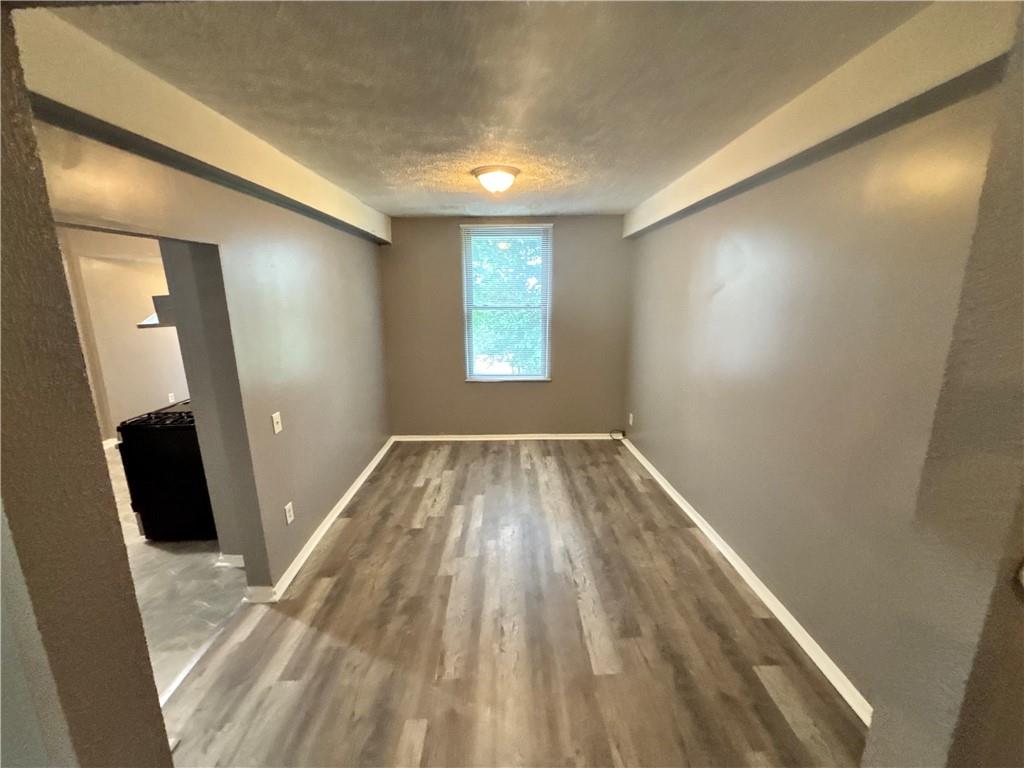335 Cedarhurst Street Pittsburgh, PA 15210 - Photo 13 of 28 wooden floor in an empty room with a window