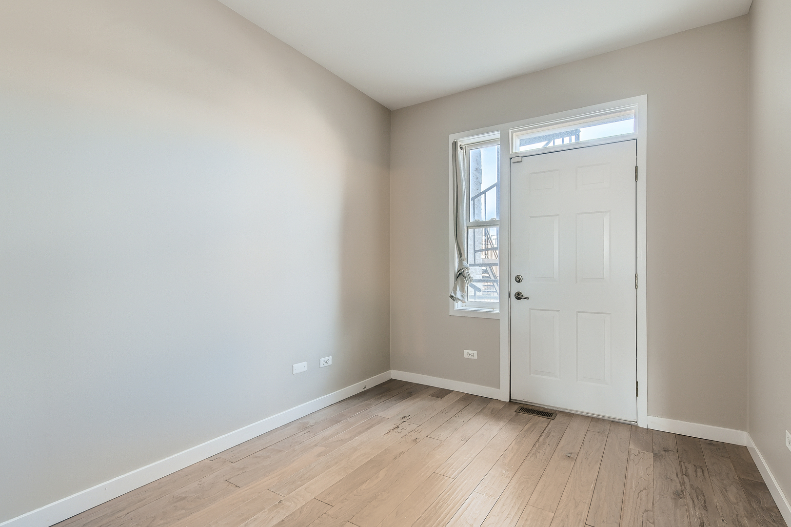 1318 West Grenshaw Street, Unit B Chicago, IL 60607 - Photo 13 of 16 wooden floor in an empty room