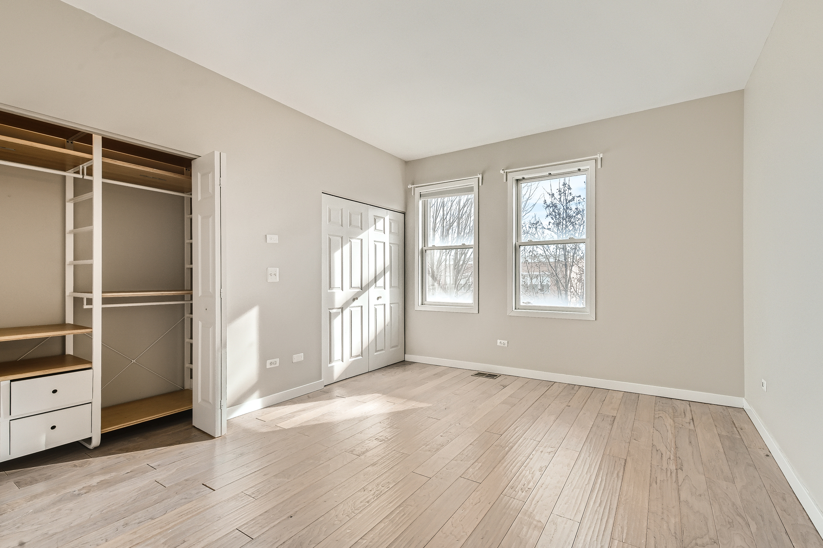 1318 West Grenshaw Street, Unit B Chicago, IL 60607 - Photo 8 of 16 wooden floor in an empty room with a window
