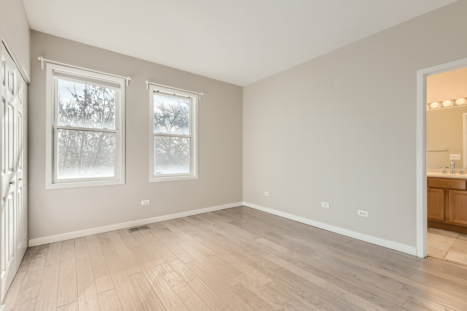 1318 West Grenshaw Street, Unit B Chicago, IL 60607 - Photo 9 of 16 a view of an empty room with a window and wooden floor