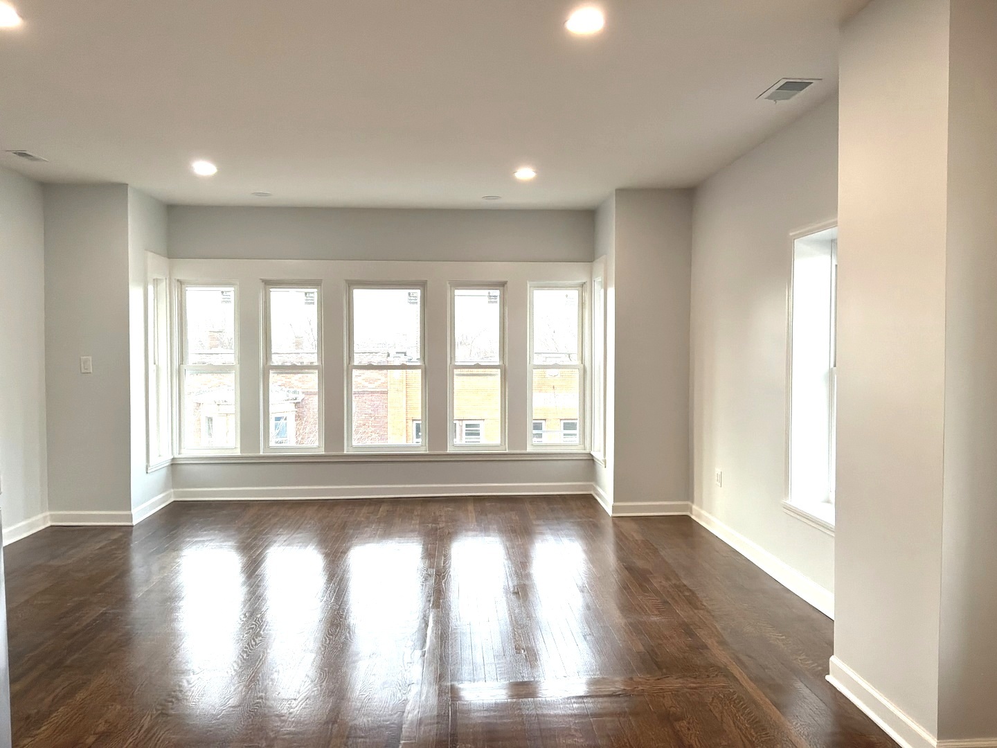224 East Cass Street, Unit 2R Joliet, IL 60432 - Photo 3 of 24 a view of empty room with wooden floor and fan