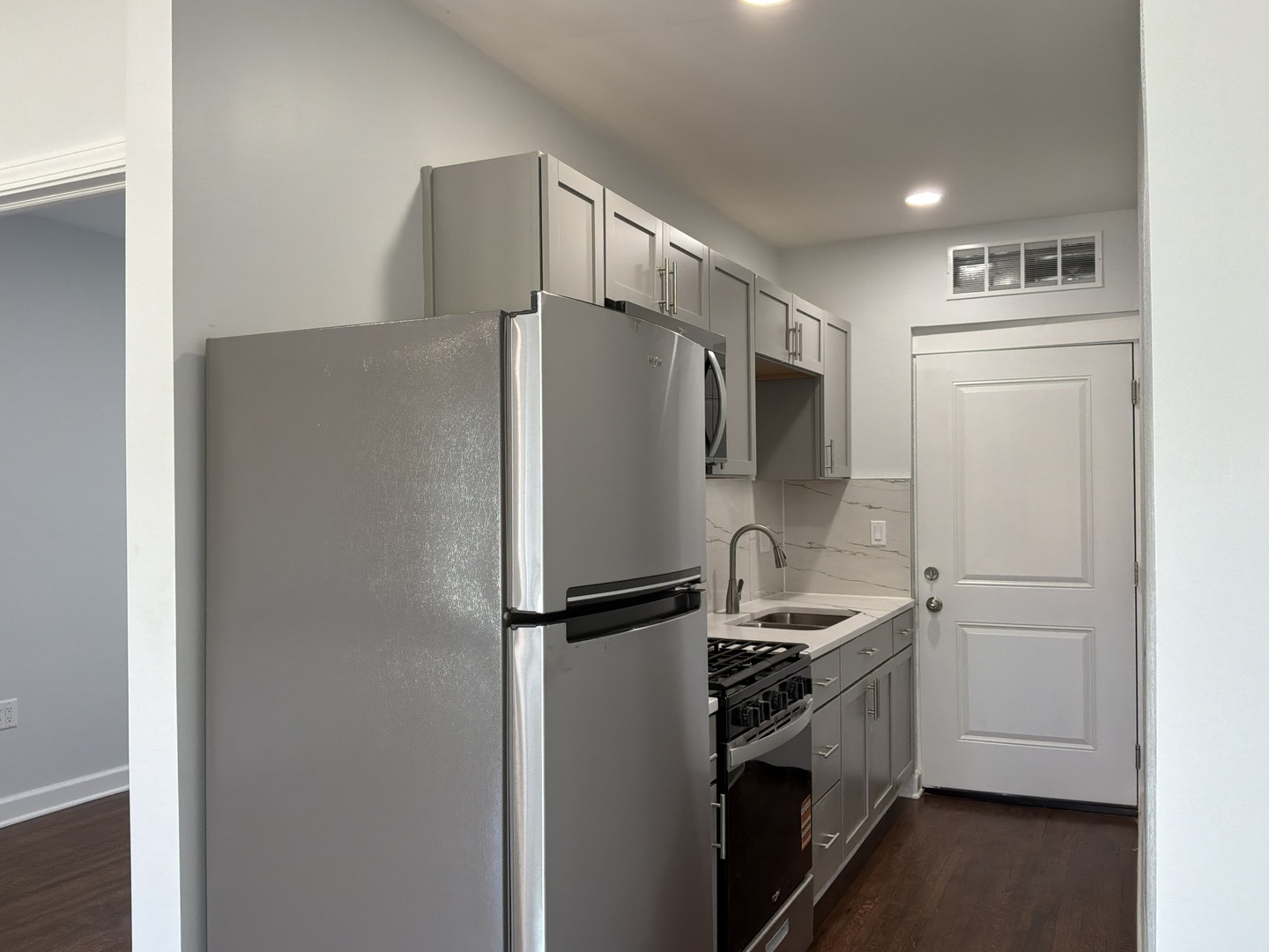 224 East Cass Street, Unit 2R Joliet, IL 60432 - Photo 7 of 24 a white refrigerator freezer and a stove sitting inside of a kitchen