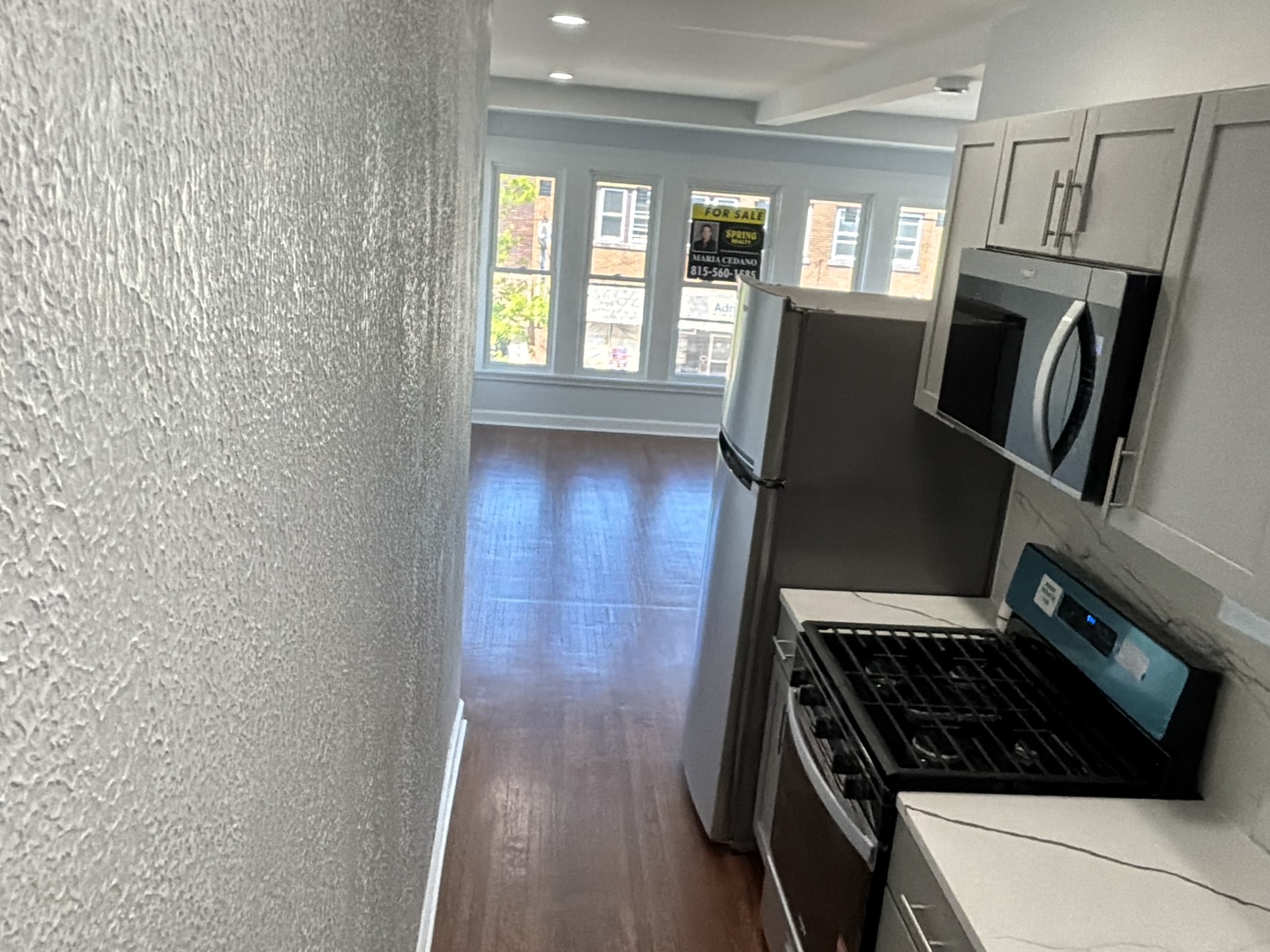 224 East Cass Street, Unit 2R Joliet, IL 60432 - Photo 8 of 24 a view of a kitchen with wooden floor and a window