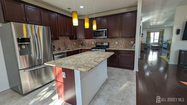a kitchen with granite countertop stainless steel appliances and wooden cabinets