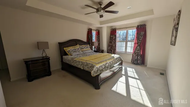 a bedroom with a bed dresser and a window