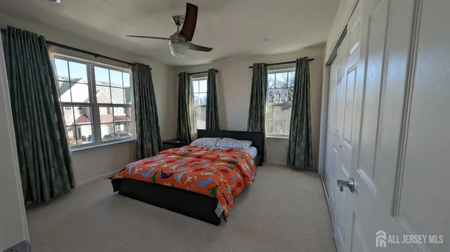 a bedroom with a bed next to a window