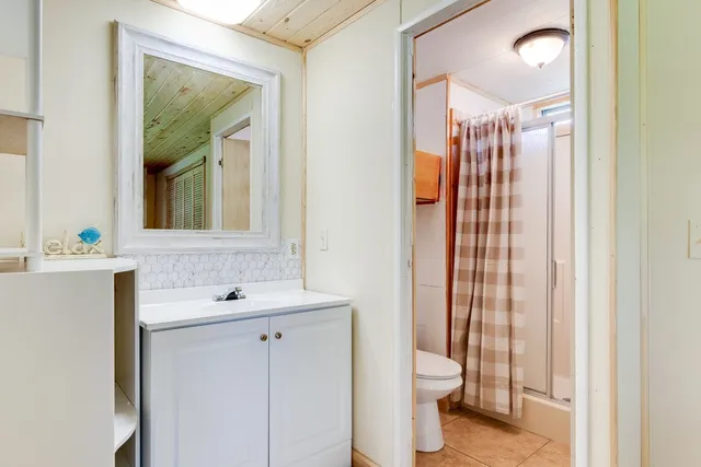 a view of a bathroom with a shower and a sink
