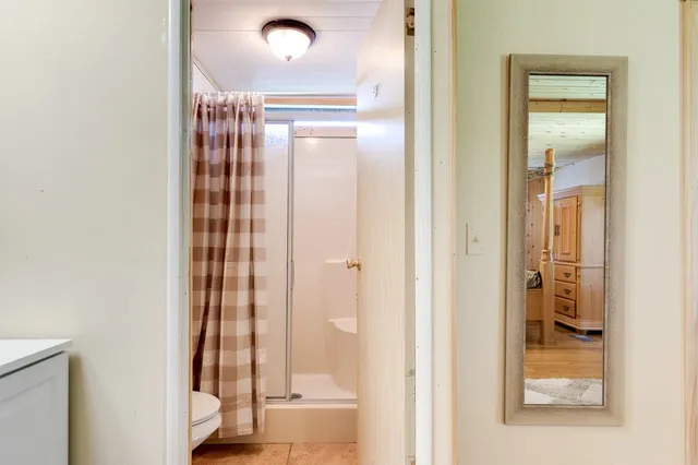 a view of a room with window and hardwood floor