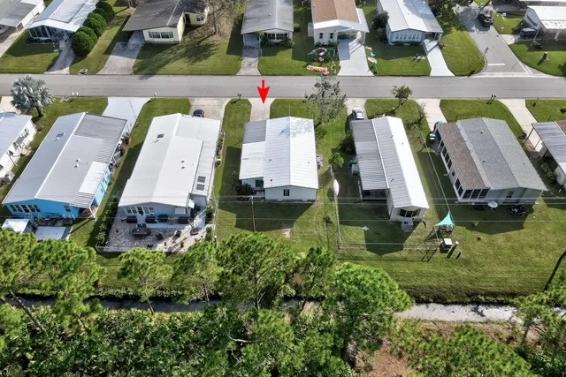 an aerial view of a house with garden space and street view