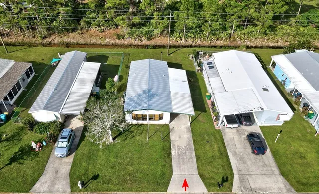 a front view of a house with a yard table and trees
