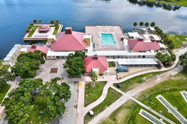 an aerial view of a house with a yard and lake view
