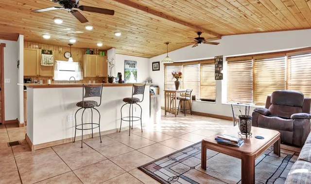 a living room with lots of furniture and a dining table