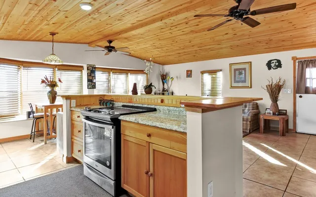 a kitchen with stainless steel appliances granite countertop a sink stove and cabinets