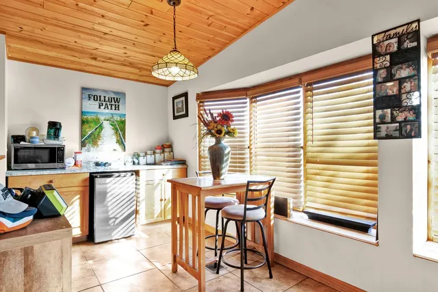 a spacious bedroom with a bed and a chandelier