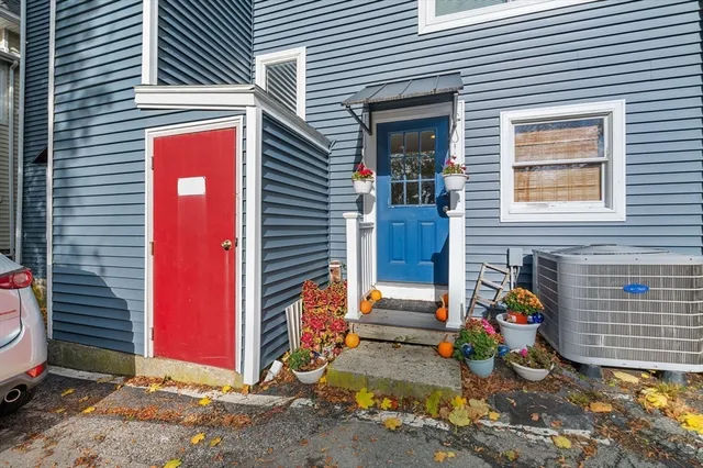 an aerial view of a house with a yard and large tree