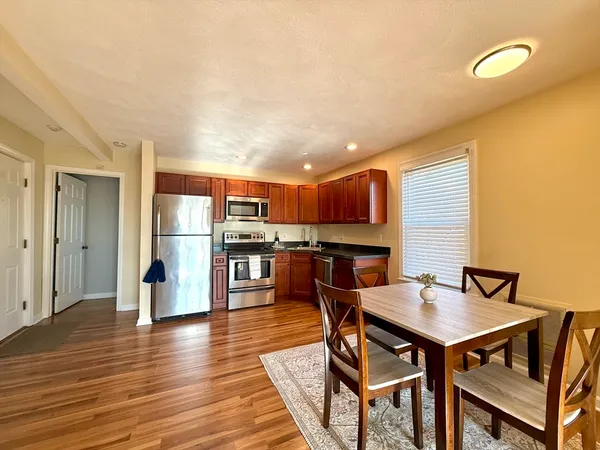 a view of a dining room with furniture and wooden floor