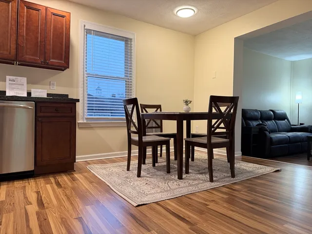 a view of a livingroom with furniture window and wooden floor