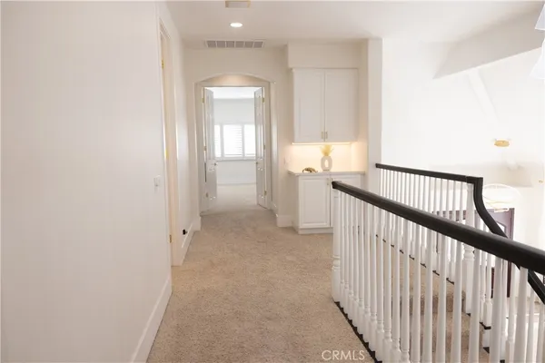 a view of a hallway view with three rooms