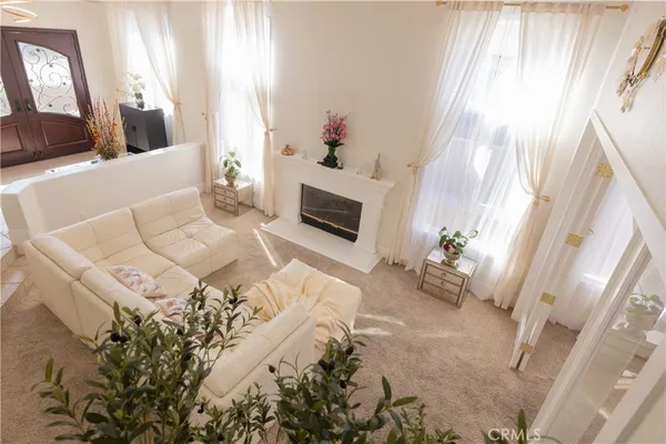 a living room with furniture and a fireplace