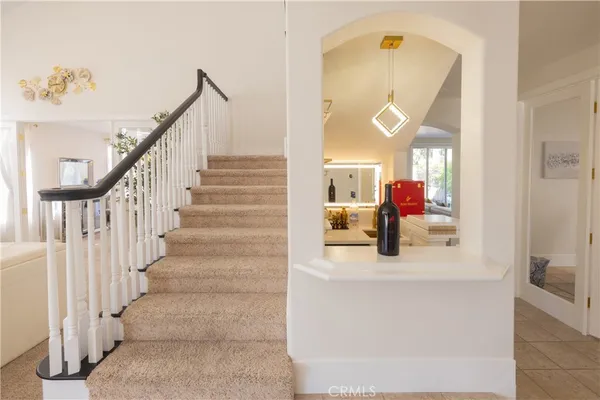 a view of staircase with a view of living room