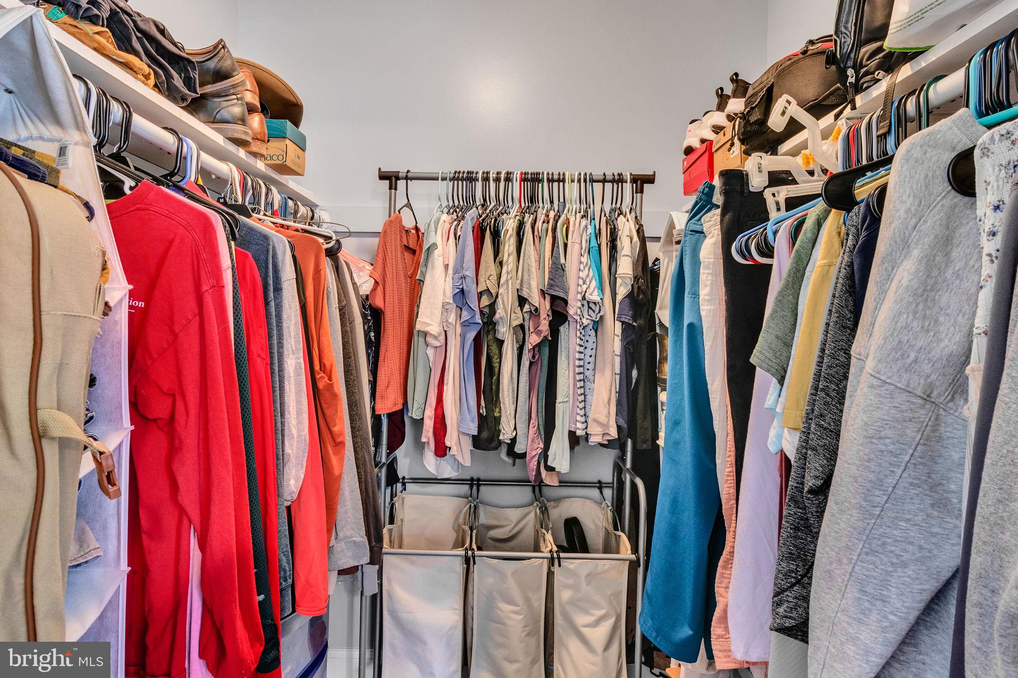 9832 River Road Lancaster, VA 22503 - Photo 33 of 68 Organized closet with vibrant attire.