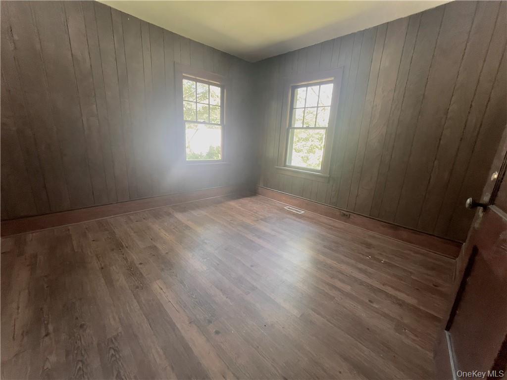 4 Old Turnpike Road Bloomingburg, NY 12721 - Photo 13 of 27 Spare room featuring wood walls and wood-type flooring