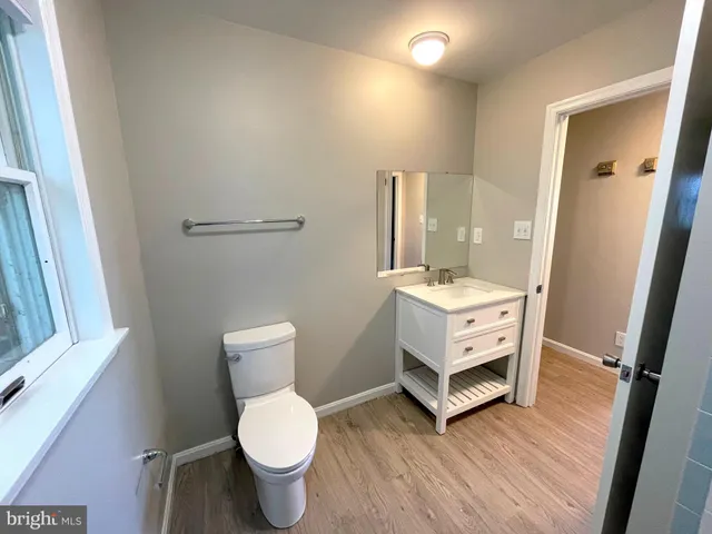 a bathroom with a toilet sink and a mirror