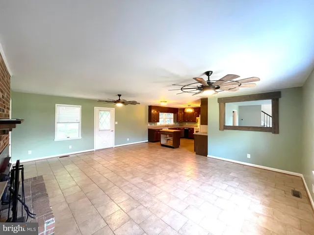 a view of a livingroom with a piano and wooden floor