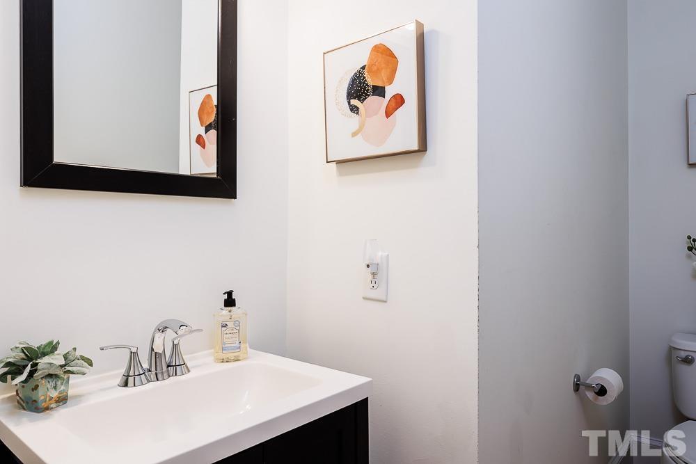 6814 Gloucester Road Raleigh, NC 27612 - Photo 15 of 35 a bathroom with a sink and a mirror