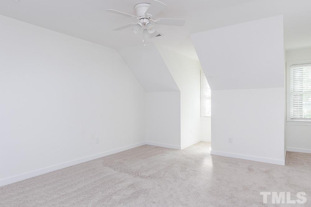 6814 Gloucester Road Raleigh, NC 27612 - Photo 24 of 35 an empty room with a window and ceiling fan