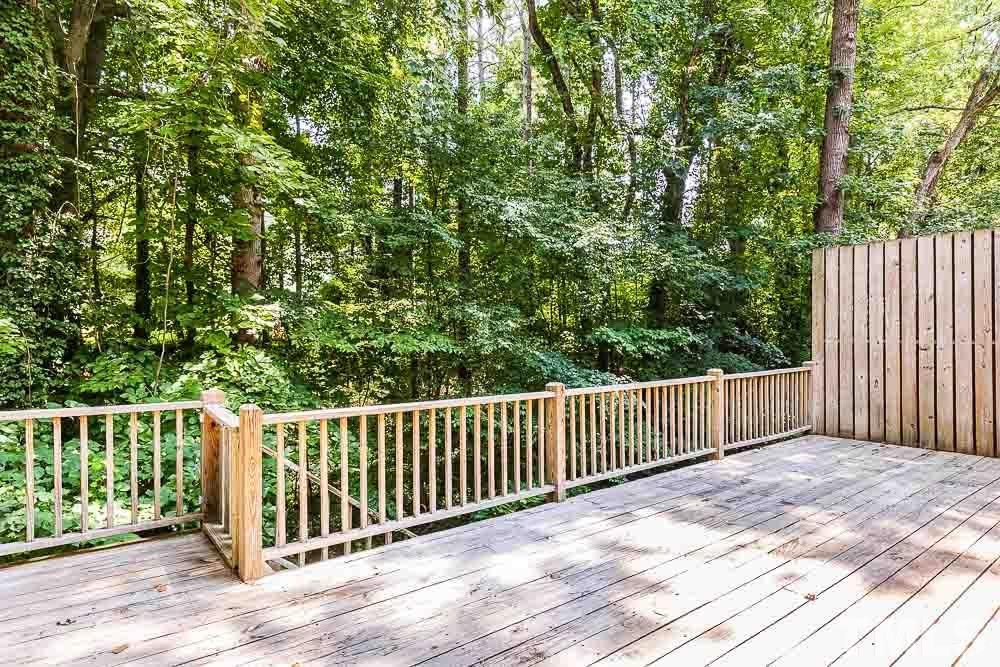 6814 Gloucester Road Raleigh, NC 27612 - Photo 27 of 35 a balcony with wooden floor and fence