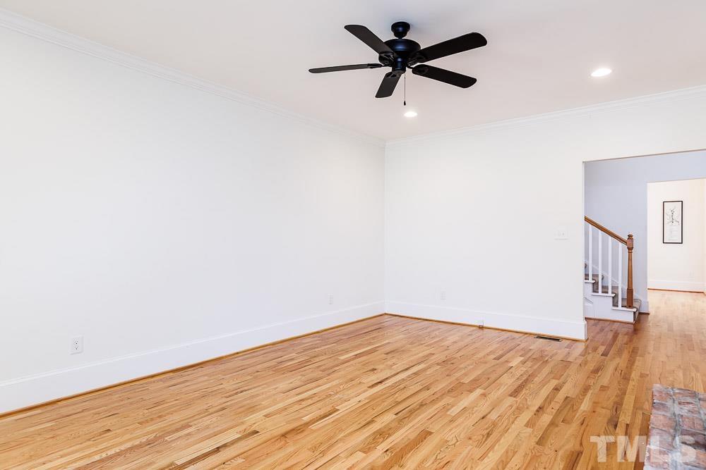 6814 Gloucester Road Raleigh, NC 27612 - Photo 5 of 35 a view of empty room with wooden floor