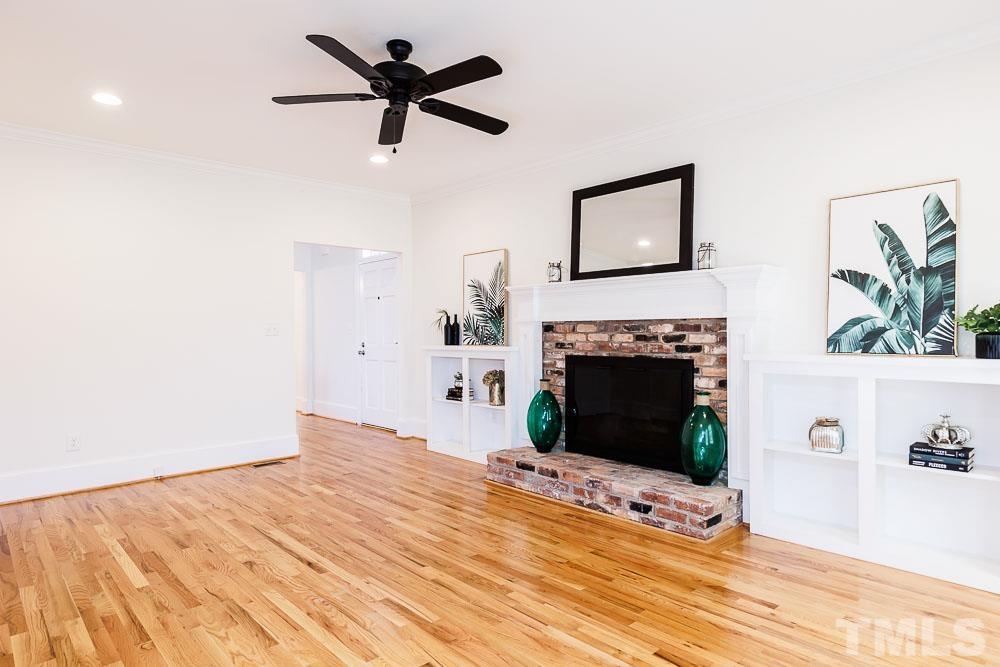 6814 Gloucester Road Raleigh, NC 27612 - Photo 6 of 35 a view of a livingroom with a fireplace and window
