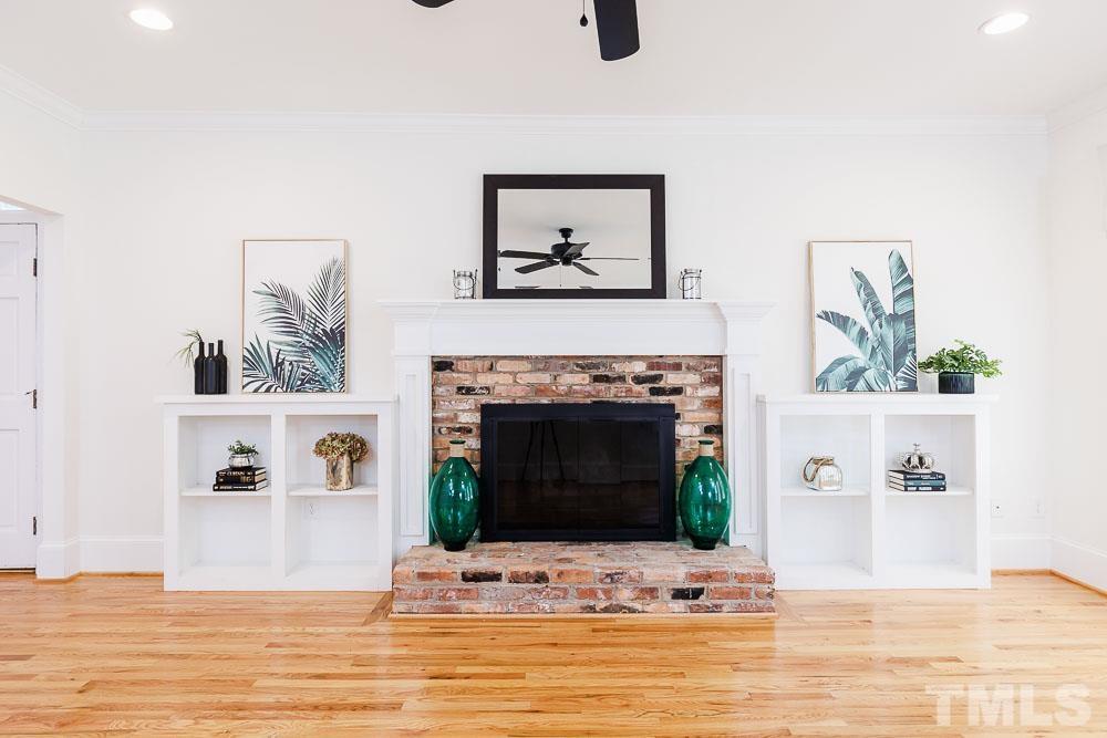 6814 Gloucester Road Raleigh, NC 27612 - Photo 7 of 35 a view of a livingroom with a fireplace and window