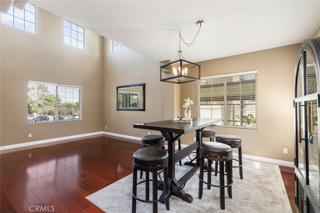 1430 Baldwin Drive Corona, CA 92881 - Photo 15 of 61 a view of a dining room with furniture a chandelier and wooden floor