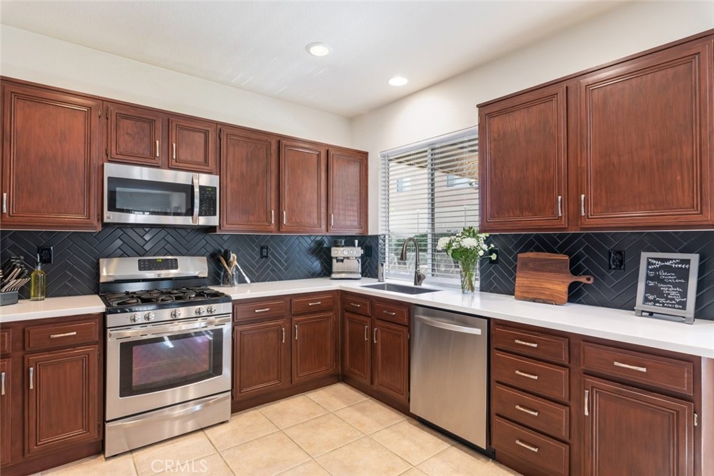 1430 Baldwin Drive Corona, CA 92881 - Photo 23 of 61 a kitchen with a sink stove and microwave