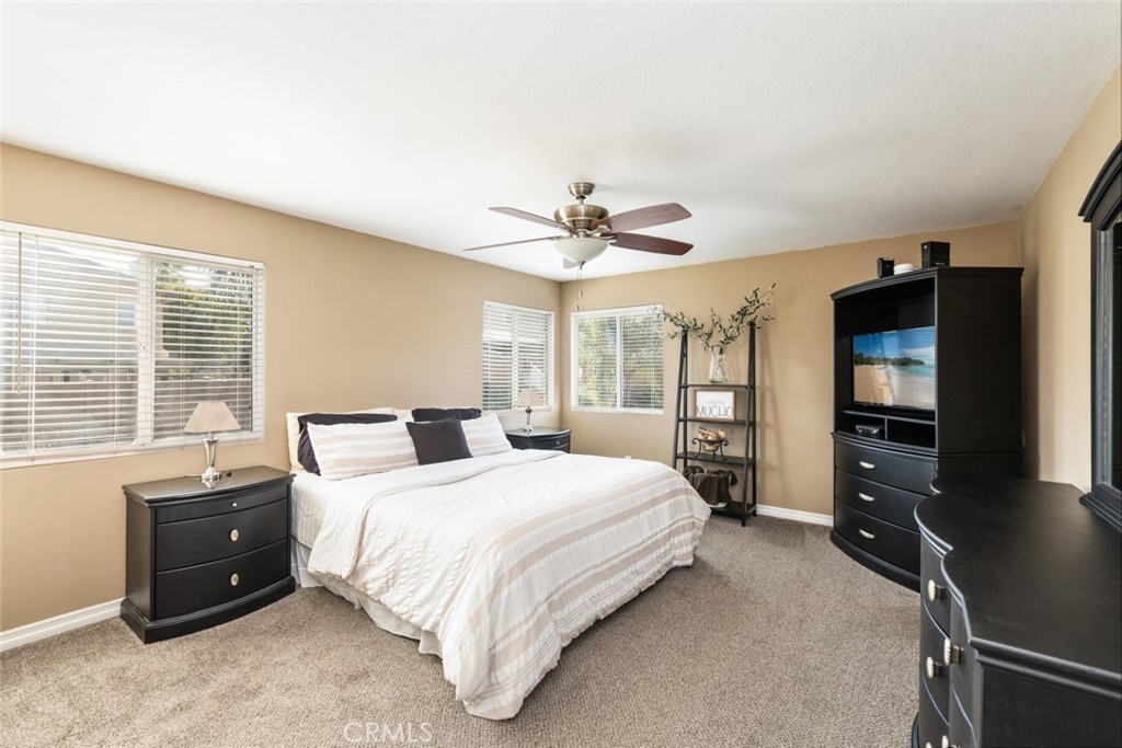 1430 Baldwin Drive Corona, CA 92881 - Photo 27 of 61 a bedroom with a bed and a flat tv screen on dresser