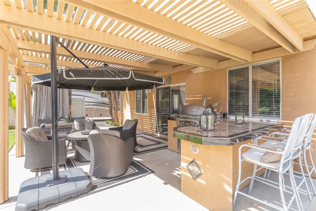 1430 Baldwin Drive Corona, CA 92881 - Photo 42 of 61 The covered patio offers a perfect outdoor retreat with a built-in BBQ, seating, and pergola shading.