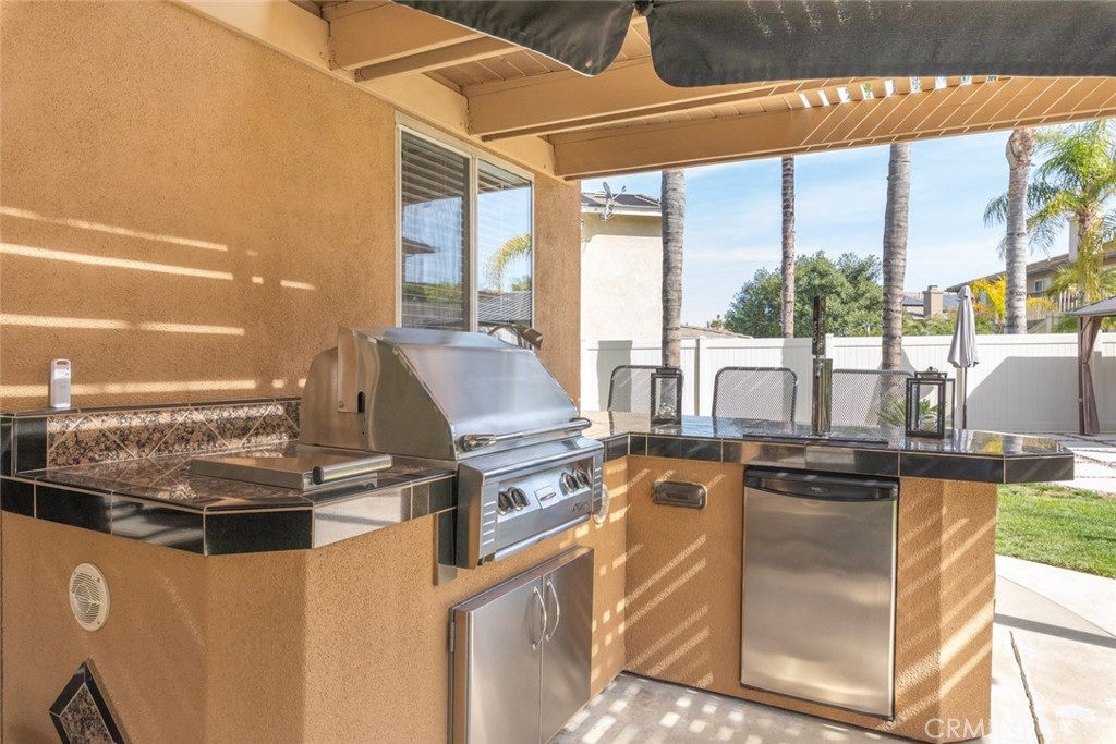 1430 Baldwin Drive Corona, CA 92881 - Photo 44 of 61 a kitchen with stainless steel appliances granite countertop a stove a sink and a refrigerator