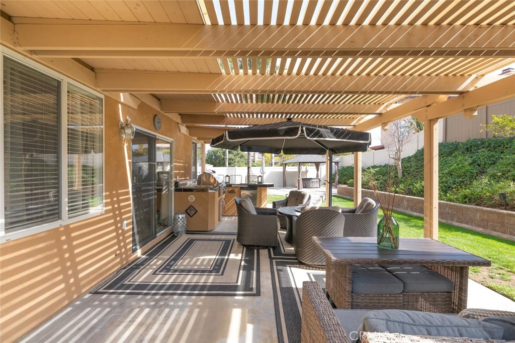 1430 Baldwin Drive Corona, CA 92881 - Photo 45 of 61 a view of a patio with chairs and floor to ceiling window