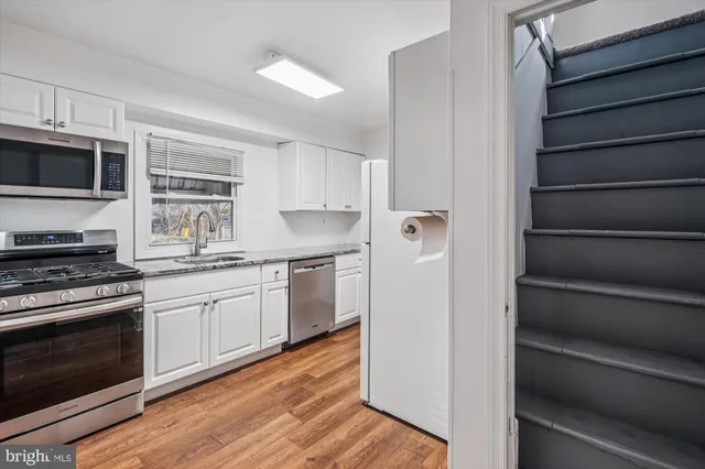 a kitchen with granite countertop cabinets and steel stainless steel appliances