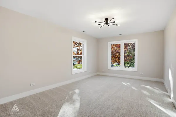 a bedroom with furniture and a large window