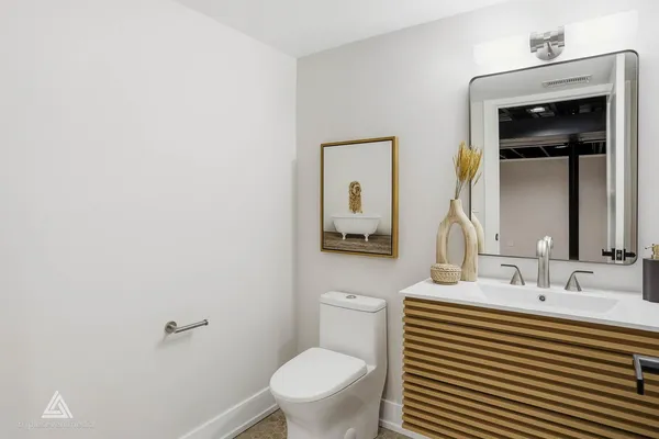 a bathroom with a toilet a sink and mirror