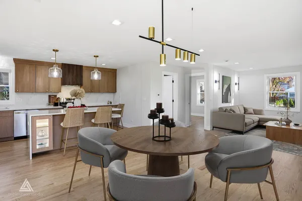 a kitchen with a table chairs sink and cabinets