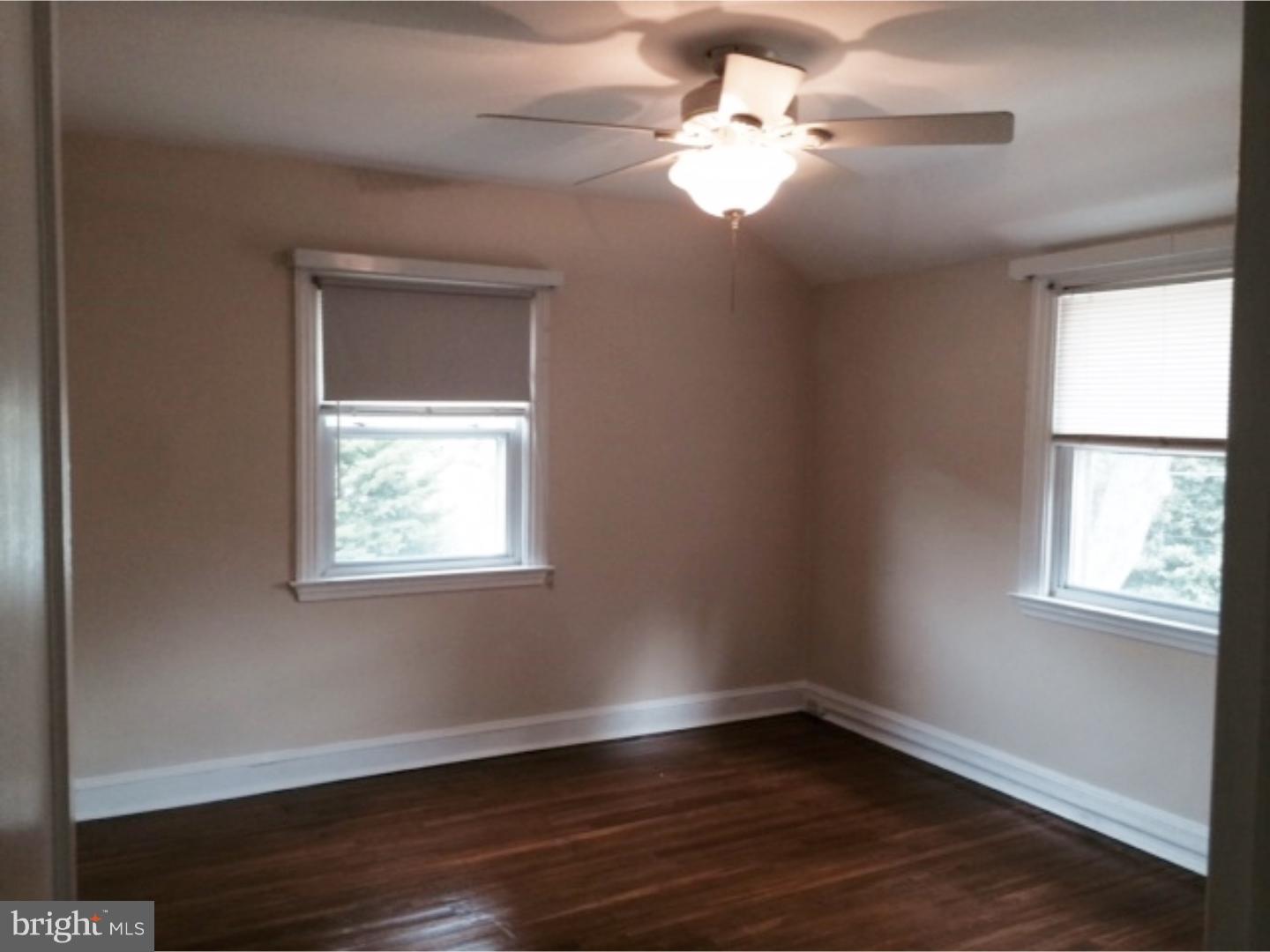 737 Hilltop Road Springfield, PA 19064 - Photo 15 of 24 a view of an empty room with wooden floor and a window